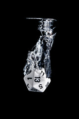 Splash photography of a 20 faces dice dropped in water with black background