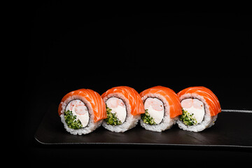 Delicious Fresh Salmon Sushi Rolls Presenting Exquisitely on a Black Background