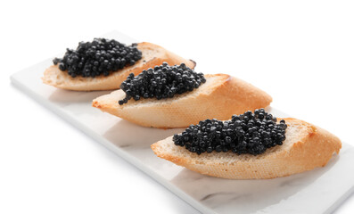 Tasty bruschettas with black caviar on white background