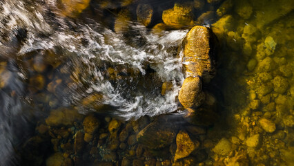 Flowing river, river stones background, water stream