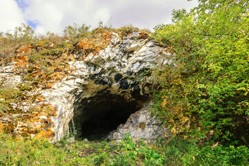 Mountain cave in Ustinovskii Canyon in Southern Urals, Russia - summer mountain landscape view of...