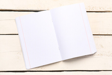 Blank copybook pages on white wooden background