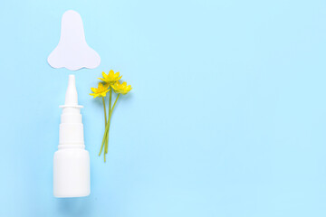 Bottle of drops with paper nose and flowers on blue background. Seasonal allergy concept