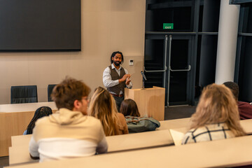 University professor giving a lecture to students in modern amphitheater