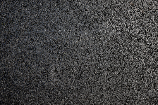 Neu geteerter Asphalt auf einer strasse von oben photografiert