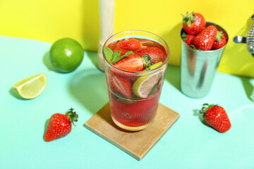 Glass of delicious strawberry mojito on color background, closeup