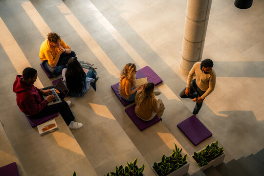 Diverse students collaborating and learning in modern university building
