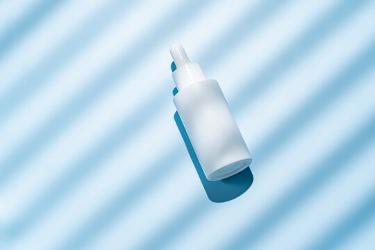 Serenity Blue background with white cosmetics bottle