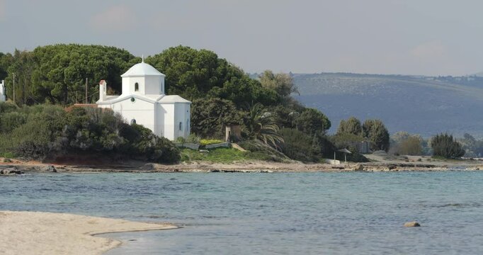 Small white chapel on the beach of Nea Makri, Greece