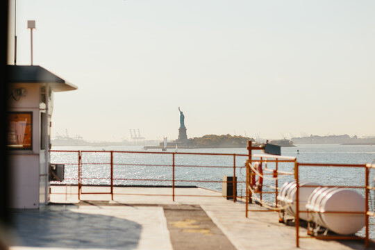 View of the statue of liberty from a ferry in sunlight in New York