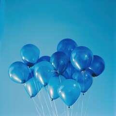 A cluster of blue balloons floating joyfully against a bright sky