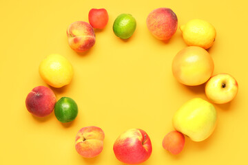 Frame made of different fresh fruits on yellow background