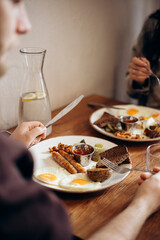 Plate of English breakfast with eggs and sausages at hotel restaurant.