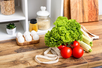 Mesh bag with different fresh vegetables on counter in kitchen, closeup