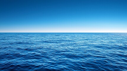 Obraz premium Calm ocean surface under vibrant blue sky