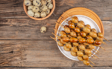 smoked eggs quail on a skewer bio organic eggs from local farm, top view. copy space