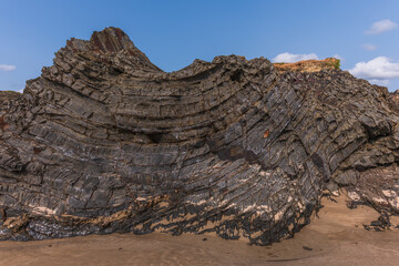 A rock with many holes and grooves, strange shapes in volcanic rock.