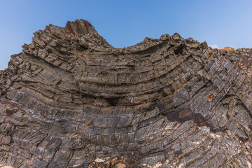 A rock with many holes and grooves, strange shapes in volcanic rock.