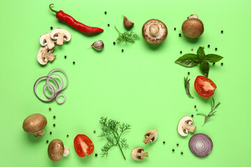 Frame made of fresh mushrooms with tomato and different spices on green background