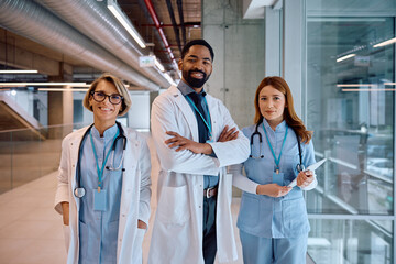 Multiracial team of medical experts at clinic looking at camera.