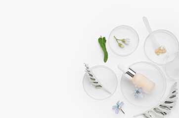 Petri dishes with sample, herbs and bottle of cosmetic product on white background