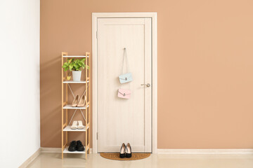 Interior of hall with door, mat and shoe stand