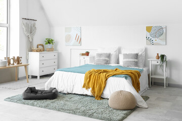 Interior of light bedroom with pet bed