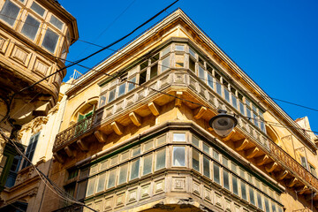 Typical narrow streets with colorful balconies in VallettaTypical narrow streets with colorful balconies. Narrow streets with colourful window boxes in Valetta, MaltaTraditional Maltese balconies in V