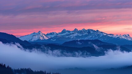 Dramatic natural lighting highlights misty clouds over mountain range at twilight