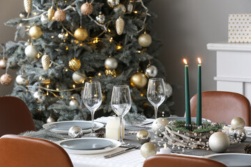 Dining table with setting for Christmas celebration in living room