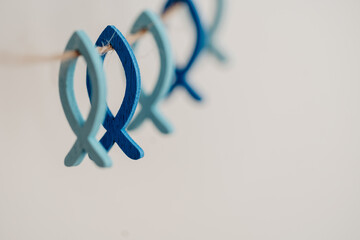 Kleine blaue Fische aus Holz an natur Schnur - Symbol für Glaube und Religion
