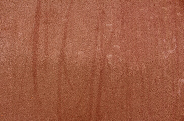 red rubber coating on the ground with water droplets