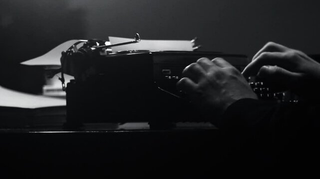 Man typing on an old typewriter in a moody office setting &ndash; vintage atmosphere and analog charm