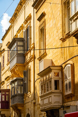 Typical narrow streets with colorful balconies in VallettaTypical narrow streets with colorful balconies. Narrow streets with colourful window boxes in Valetta, Malta Traditional Maltese balconies