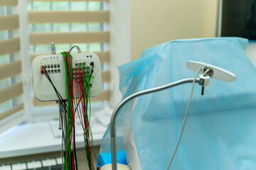 Patient monitoring setup. Medical equipment is prepared for a patient, featuring numerous connected...