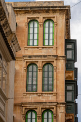 Street scenes in the old town of Valletta (Il-Belt) the capital of Malta.A residential block on Triq il-Punent in Valletta, with St. Paul's Anglican Cathedral on the right.