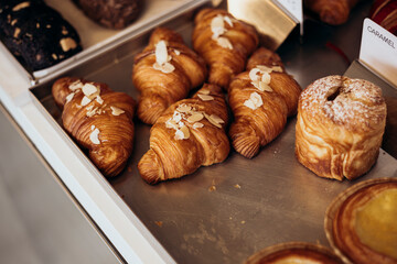 Almond croissants in the bakery, coffee shop, close up.