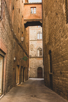 Fototapeta The architecture and narrow streets of the city of Siena in Italy
