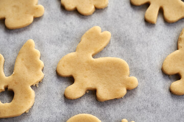 Linzer cookie in the shape of Easter bunny cut out from raw pastry dough