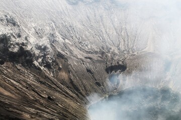 Dramatic view of Mount Bromo volcano with smoke billowing from its crater © Okki