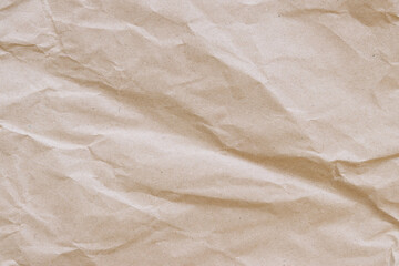 Crumpled craft paper background. Crumpled craft paper texture or paper background. Background with copy space. Top view. Space for text. Close-up view of crumpled brown paper texture