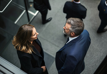 Top-down view of business professionals discussing strategy in a modern corporate environment