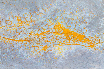 Cracked earth texture with vibrant orange and gray hues