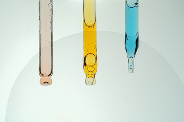 Close up of colorful liquids in three pipettes