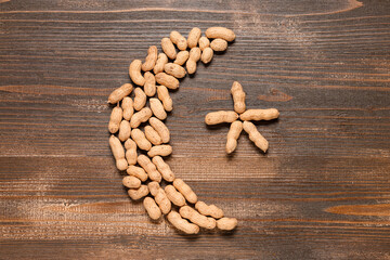 Crescent and star made of peanuts on wooden background. Ramadan celebration