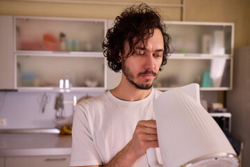 Unboxing a stylish, modern kettle designed for use in a bright, contemporary kitchen space