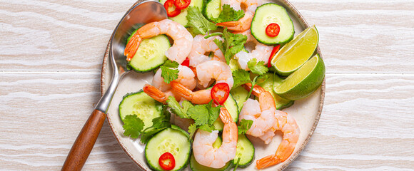 Delicious shrimp salad with fresh ingredients on white table, perfect for healthy meals in summer. Top down view of prawn with vegetables salad, ideal for showcasing culinary skills