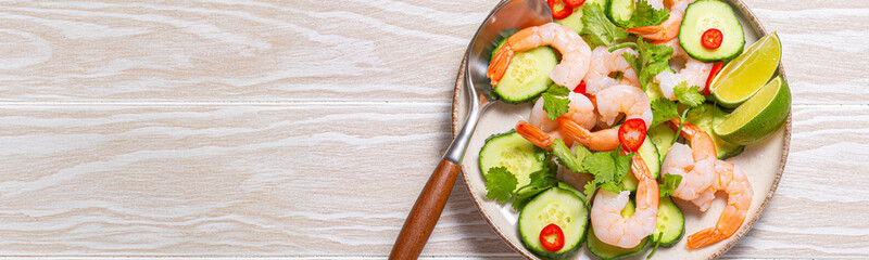 Delicious shrimp salad with fresh ingredients on white table, perfect for healthy meals in summer. Top down view of prawn with vegetables salad, ideal for showcasing culinary skills