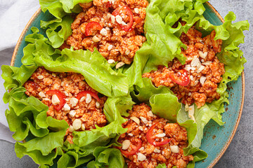 Lettuce wraps filled with a savory mixture of minced meat, herbs, and spices, creating a flavorful...