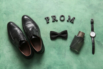 Word PROM, shoes, bow tie, perfume and wristwatch on green grunge background